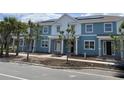 Beautiful two-story home with a blue exterior, white trim, and solar panels on the roof at 6476 Barnstorm Way, St Cloud, FL 34771
