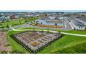 Aerial view of community garden with raised beds and lush landscaping in a residential neighborhood at 6480 Barnstorm Way, St Cloud, FL 34771
