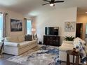Cozy living room featuring vaulted ceilings, neutral tones, comfortable seating, and stylish decor at 680 Joseph Way, The Villages, FL 34762