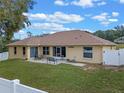 Aerial view of the backyard, featuring a patio, well-maintained lawn, and fenced perimeter at 847 Cumberland Cir, Minneola, FL 34715