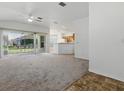 Open-concept living room flows into kitchen and offers ample natural light through sliding glass doors at 8601 Se 133Rd St, Summerfield, FL 34491
