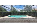 Enjoy the outdoors in this screened-in pool area, perfect for relaxation and entertainment at 8719 Kenmure Cv, Orlando, FL 32836