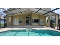 Relax in this pool area featuring a covered patio and clear views of the refreshing blue pool at 8719 Kenmure Cv, Orlando, FL 32836