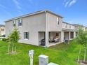 Home featuring a covered patio, grill, and well-maintained lawn at 1042 Lido Dr, Howey In The Hills, FL 34737