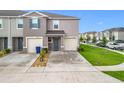 Well-maintained home featuring a one-car garage, blue door, and a neatly landscaped front yard at 1042 Lido Dr, Howey In The Hills, FL 34737