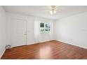 Bright living room with hardwood floors, white walls, and natural light at 11214 Sw 77Th Ct, Ocala, FL 34476