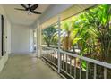 Inviting screened-in porch with ceiling fan and view of lush greenery at 11442 Beggs Ct, Clermont, FL 34711