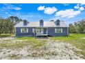 Charming home with a metal roof, white trim, and a well-maintained front lawn at 11920 Kijik Trl, Groveland, FL 34736