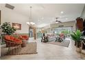 Open-concept living room with neutral tones, tile flooring, and sliding doors to the patio at 1304 Zombar Pl, The Villages, FL 32163