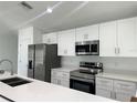 Modern kitchen featuring stainless steel appliances, pristine white cabinetry, and sleek countertops at 13430 Sw 105Th Place, Dunnellon, FL 34432