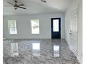 Bright living room showcasing modern flooring, fresh paint, natural light from windows, and an inviting atmosphere at 13430 Sw 105Th Place, Dunnellon, FL 34432