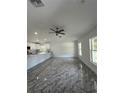 Open-concept living space with stylish flooring, recessed lighting, and seamless flow to the kitchen at 13430 Sw 105Th Place, Dunnellon, FL 34432