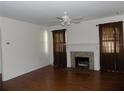 Spacious living room featuring hardwood floors, a decorative fireplace, and natural lighting at 1485 Morningside Dr, Mount Dora, FL 32757