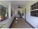 Bright and airy porch with tiled floor, lots of windows, and a ceiling fan at 1485 Morningside Dr, Mount Dora, FL 32757