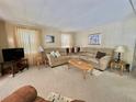 Inviting living room featuring a comfortable sectional sofa and neutral decor at 152 Dogwood Trl, Leesburg, FL 34748