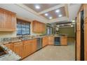 Kitchen features stainless steel appliances, light wood cabinets, granite countertops and a wine fridge at 15935 J And J Dr, Tavares, FL 32778