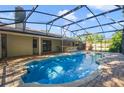 Inviting pool with an expansive screened-in lanai area, perfect for relaxing and entertaining outdoors at 15935 J And J Dr, Tavares, FL 32778
