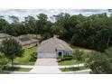 Aerial view of a well-maintained home with a manicured lawn and lush surrounding greenery at 179 Birchmont Dr, Deland, FL 32724