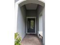 Inviting entryway with brick flooring and a stylish front door, leading into the home at 179 Birchmont Dr, Deland, FL 32724