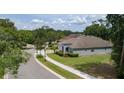 Street view of a charming home with lush landscaping, sidewalk, and a well-manicured lawn at 179 Birchmont Dr, Deland, FL 32724