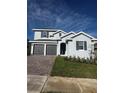 Charming two-story home with a brick driveway and well-maintained landscaping at 1881 Sunshine Peak Dr, Minneola, FL 34715