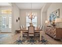 Bright dining room with an elegant chandelier, stylish furniture, and a neutral color palette at 2204 Baypoint Way, The Villages, FL 32162