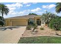 Charming home exterior featuring a well-manicured lawn, lush landscaping, and a paved driveway at 2204 Baypoint Way, The Villages, FL 32162
