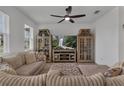 Open living room featuring comfortable seating and a modern entertainment center at 2552 Chickasaw Plum Loop, Clermont, FL 34711