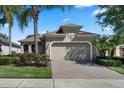 Charming single-Gathering home with a brick paver driveway and well-manicured landscaping at 2602 Stargrass Cir, Clermont, FL 34715
