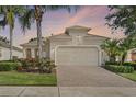 Charming single-Gathering home with a brick paver driveway and well-manicured landscaping at 2602 Stargrass Cir, Clermont, FL 34715