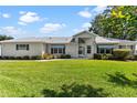 Inviting single-story home with tidy landscaping and well-kept lawn at 26030 Newcombe Cir, Leesburg, FL 34748