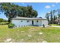 Beautiful single-story home with manicured lawn, and an attached garage in a rural setting at 2845 County Road 523, Wildwood, FL 34785