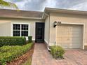 A front exterior view of a well-kept home with desert landscaping, stone-paved driveway, and a 2-car garage at 3205 Sonesta Ct # B, Clermont, FL 34711