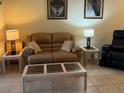 Cozy living room with plush seating, a glass-top coffee table, and neutral decor for a welcoming atmosphere at 3205 Sonesta Ct # B, Clermont, FL 34711