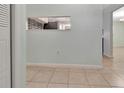 View of the spacious, empty room with tile flooring and light-blue painted walls at 3380 Blossom St, Kissimmee, FL 34746