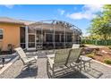 Outdoor patio with gravel, comfortable seating, and a screened enclosure, perfect for relaxing at 34021 Park Ln, Leesburg, FL 34788
