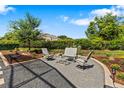 Outdoor patio area features comfortable seating on gravel with landscaping, ideal for relaxation at 34021 Park Ln, Leesburg, FL 34788