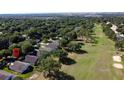 Aerial view of the property within a golf course community with lush greenery and mature trees at 3706 Doune Way, Clermont, FL 34711