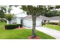 Well-maintained single Gathering home featuring a lush front lawn and two car garage at 3821 Doune Way, Clermont, FL 34711
