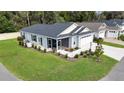 Beautiful single-story home with a manicured lawn, screened porch and landscaped backyard at 3984 Kanawha Pl, The Villages, FL 32163