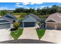 Wide view of a single Gathering home featuring well-maintained landscaping and a private driveway at 4451 Elijah Loop, The Villages, FL 32163