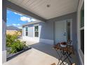 Inviting front porch with stylish decor offering a cozy and welcoming entrance to the home at 4451 Elijah Loop, The Villages, FL 32163