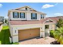 Charming home with a two-car garage, brick driveway, manicured lawn, and a welcoming front porch at 4869 Grassendale Ter, Sanford, FL 32771