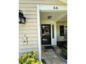 Home featuring an inviting front entrance with a charming welcome sign and colorful decorations at 66 Elmwood Trl, Deland, FL 32724