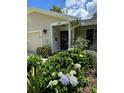 Home featuring a lovely front porch adorned with beautiful flowering bushes and tasteful decorations at 66 Elmwood Trl, Deland, FL 32724