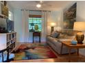 Cozy living room with a comfortable sofa, a colorful rug, and bright natural light at 66 Elmwood Trl, Deland, FL 32724