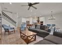 Open floor plan featuring spacious living room with staircase, kitchen with bar seating, and dining area at 7627 Taormina Way, Clermont, FL 34714