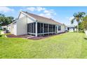 Well-maintained backyard featuring a screened-in lanai and lush lawn at 815 Cortez Ave, The Villages, FL 32159