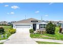 Inviting single-story home with a two-car garage, fresh landscaping, and a cozy entrance at 8178 Penrose Pl, Wildwood, FL 34785