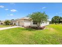 Charming home with a well-maintained lawn, landscaped garden, and mature tree, offering great curb appeal in a serene setting at 8779 Se 141St Lane Rd, Summerfield, FL 34491